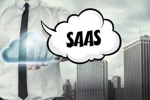 Saas text on cloud computing theme with businessman